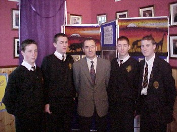 Mr Hugh Markey (Head of Business Studies and Economics) congratulates Sean Bell, Gerard McGuigan, Steven Rice and Colm O'Grady