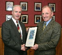 Mr. Bill Hunt, Analog Devices presents Mr. Dermot McGovern with a framed wall display to be mounted in the school. It showed two different views of a microchip, the actual size and a fascinating image of its internal makeup magnified many times.
