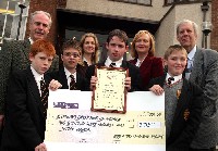 Jude Horridge, N.I. Cancer Fund for Children is presented with a cheque for 2,732 bt abbey Grammar School Pupils - Paul Toner, Myles Gray, Keith Mackey and Donal Daly. Also present are Joan Murphy, English Teacher who co-ordinated the 'Read-on' sponsered event, Pat Mooney, Head Of English and Dermot McGovern, Headmaster
